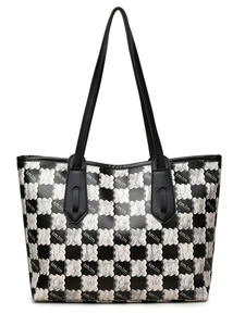 Detail view of large tote bag with black and white checkerboard and silver bear design