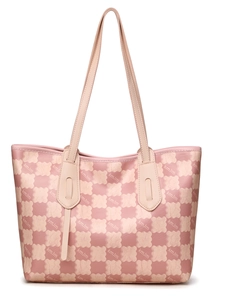 Close-up of pink checkered pattern with bear graphics on a large leather tote bag