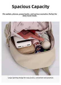 Interior view of khaki backpack showing spacious main compartment with branded pink lining