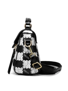 Detail of black leather handbag featuring silver cloud patterns and gold metal ring buckle