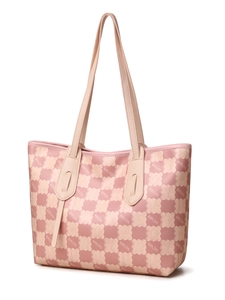 Close-up of pink tote bag featuring a monogram pattern and textured leather material