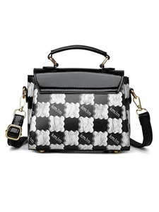 Detail of silver checkerboard cloud pattern and black leather on a stylish handbag