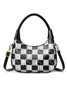 Close-up of contrast jacquard floral texture and kmJm logo on a black and silver bag