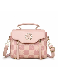 Detail of pink handbag featuring letter prints and gold flower logo with zipper accents