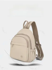 Detail view of lightweight beige nylon backpack with feathers highlighting its airy feel
