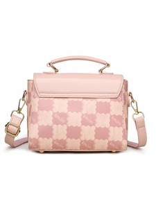 Detailed view of pink checkerboard textured handbag with gold hardware and metal feet