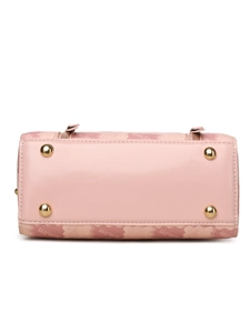 Detail of pink Boston bag base featuring four golden protective metal rivets for durability