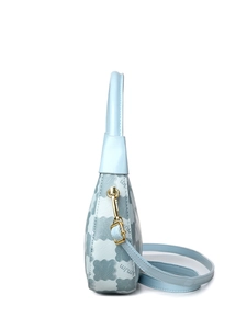 Detail of light blue crossbody bag featuring gold metal hardware and adjustable shoulder strap
