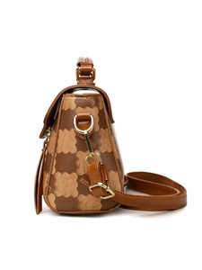 Detail of brown leather handbag with metallic hooks and teddy bear pattern design