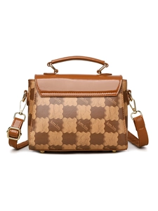 Detailed close-up of retro checkered handbag with kmJm monogram print and gold hardware