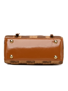 Detail view of brown Boston bag with KM monogram pattern and protective metal studs