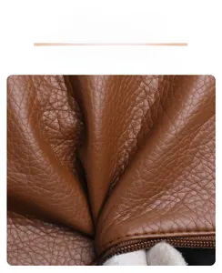 Close-up of brown pebbled leather texture and stitching detail on a trendy tote bag