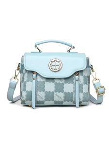 Detail showing the light blue embossed leather texture and gold circular logo on the bag