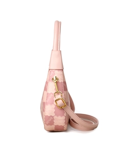 Side view of pink contrast color handbag with monogram print and gold hardware detail