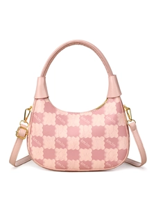 Detailed view of pink crescent bag with bear checkered pattern and gold metal buckles