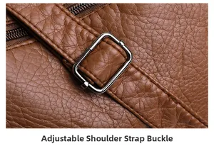 Detail of adjustable silver buckle and neat stitching on brown textured leather strap
