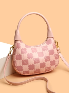 Detailed view of pink hobo bag with geometric kmJm print and golden hardware