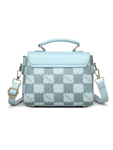 Macro shot of light blue PU handbag texture with golden hardware and monogram print
