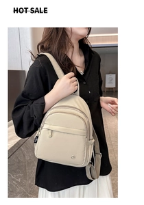 Beige nylon mini backpack featured in a casual lifestyle setting with adjustable straps