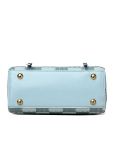 Detail view of light blue leather handbag base with four gold protective metal feet