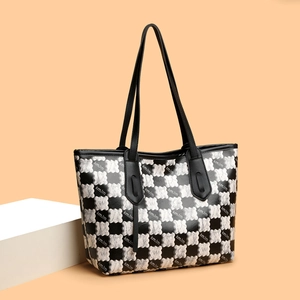 Large checkerboard tote bag with black leather straps and embossed floral texture