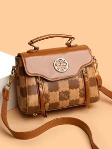 Detailed view of the brown synthetic leather handbag showing clover metal buckle and kmJm pattern