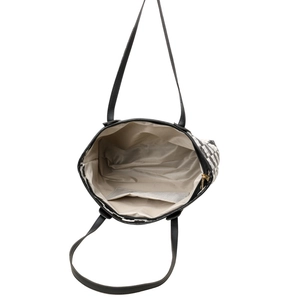 Large checkered tote bag with spacious interior and black leather straps top-down view