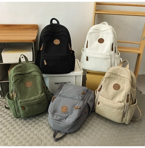 Detailed display of corduroy backpacks in black, white, green, grey, and beige colors