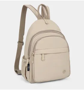 Side view of beige nylon backpack showing multiple zipper layers and side pocket
