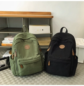 Corduroy backpacks in green and black colors showing leather logo and texture