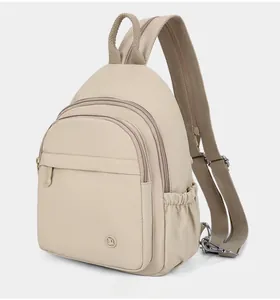 Detail of beige multifunctional backpack with three zipper compartments and side pockets