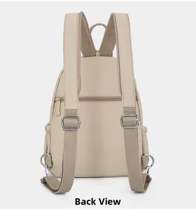Back view of beige nylon backpack showing adjustable straps and anti-theft zipper pocket