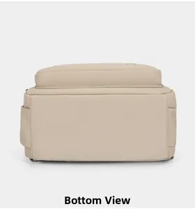Detail view of the durable bottom base and neat stitching on this beige nylon backpack