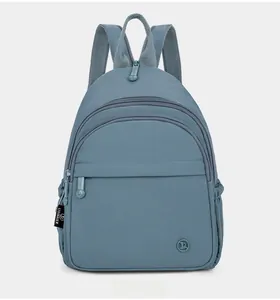 Close-up of Morandi blue nylon backpack showing wear-resistant fabric and zippers