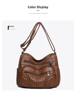 Close-up of brown PU leather bag showing lychee texture and multi-pocket zippers