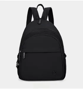 Detail of multi-compartment black nylon backpack with durable water-resistant material