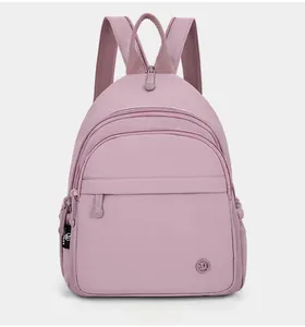 Front view of lilac waterproof nylon multi-pocket mini backpack with adjustable straps