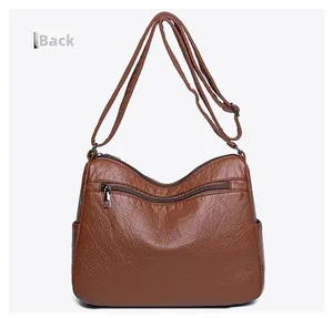 Rear view of brown PU leather crossbody bag featuring an adjustable strap and zipper pocket