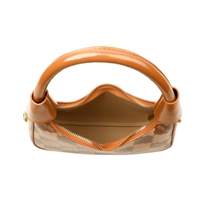 Overhead view of a retro contrast leather handbag with monogram print and top zipper