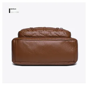 Detail view of the reinforced bottom stitching on this brown pebbled PU leather tote bag
