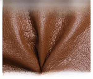 Close-up of premium brown PU leather material with litchi grain texture on tote bag