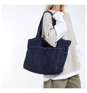 Detail of vintage denim tote bag showing side pockets and large capacity for women