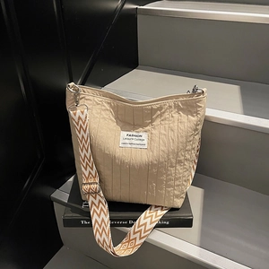 Minimalist beige pleated canvas tote bag with bohemian geometric patterned strap