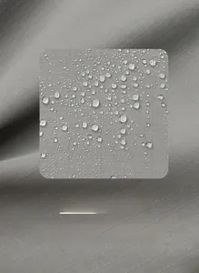 Close-up of waterproof grey nylon fabric with ripstop pattern and water droplets
