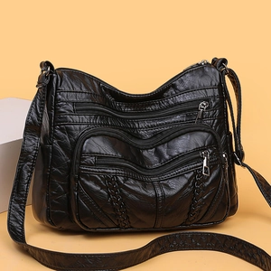 Classic black PU leather multi-pocket tote bag with woven details on a studio background