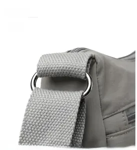 Macro detail of high-quality silver metal hardware and gray nylon fabric texture of the bag