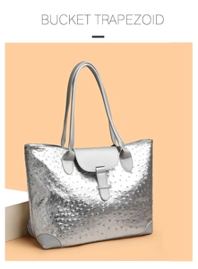 Detail of silver ostrich pattern trapezoid tote bag showing texture and metallic finish