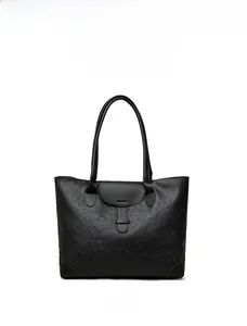 Detail of ostrich texture leather and reinforced bottom corners on a black tote bag