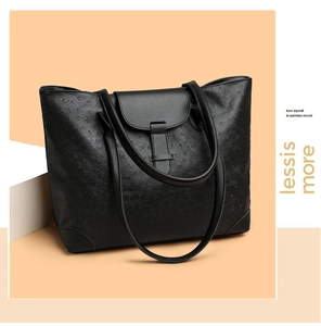 Macro side view of black ostrich texture tote bag with buckle closure and dual shoulder straps