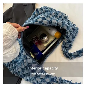 Spacious interior of blue denim shoulder bag showing room for cosmetics and daily essentials